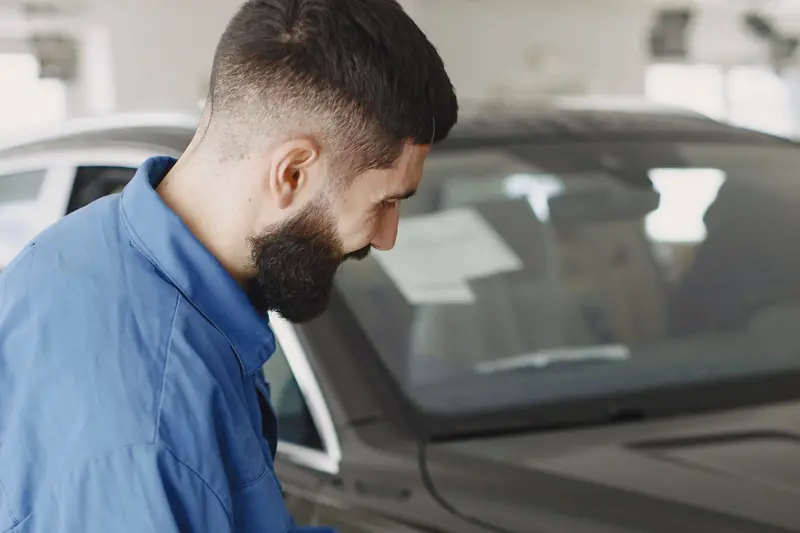 A polisher moving across a body panel