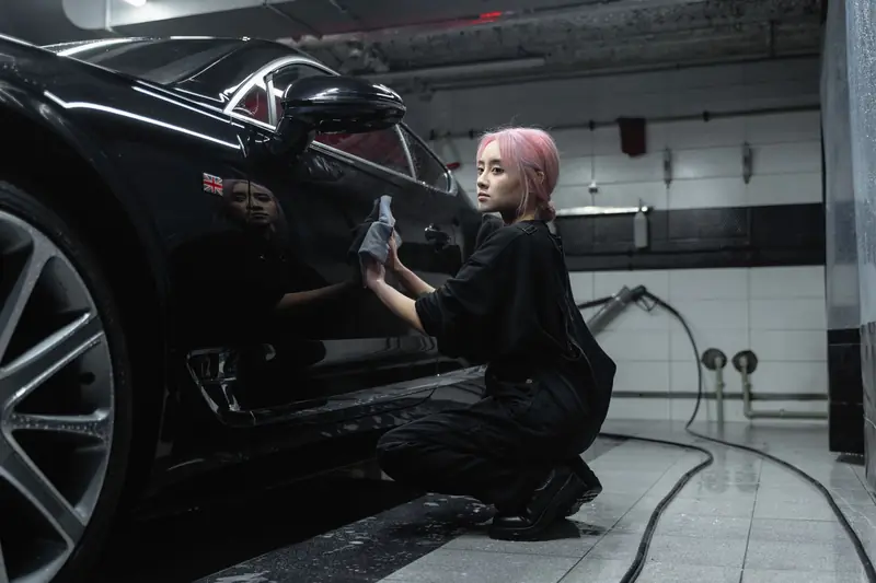 Wiping a black car after a wash