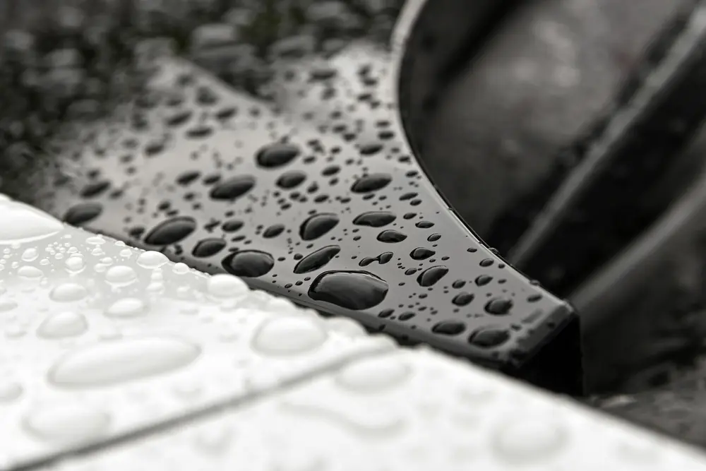Water beading on dark metallic paint
