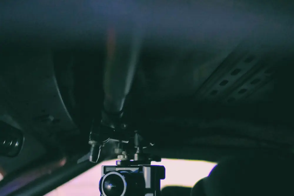 A camera rig filming from inside a car